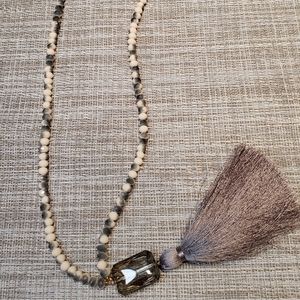 Long beaded necklace with stone and tassel drop